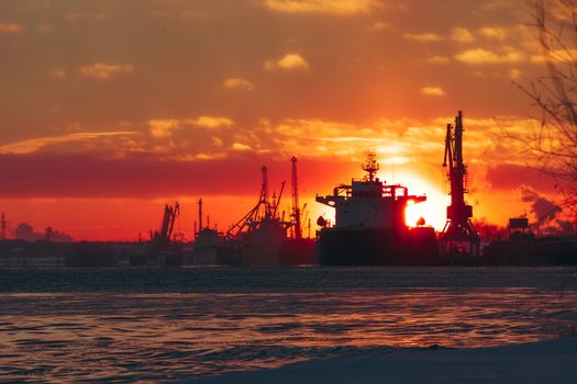 Colorful winter sunrise against the cargo port