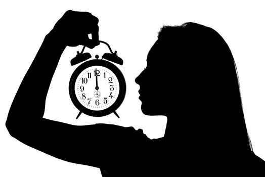 Silhouette of a woman holding an alarm clock. On the clock is a 12 o'clock.