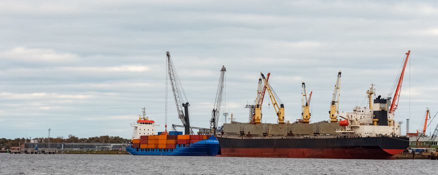 Black cargo ship loading in the port of Riga, Europe