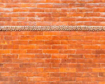 Glazed brick wall texture with a frieze in the top third