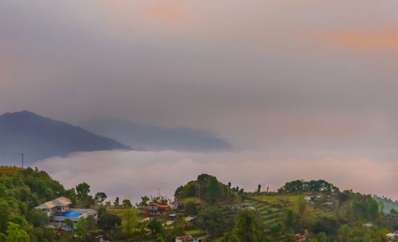 This is a photograph of vibrant color cloudy sky and mountain of a hill station near Sarangkot, Pokhara, Nepal Near Kathmandu. The image taken at dusk, at dawn, at daytime on a cloudy day. The Subject of the image is adventure, inspiration, exciting, hopeful, bright, sensational, tranquil, calm, stormy, stunning. This photography is taken in as landscape style. This photograph may be used as a background, wallpaper, screen saver.