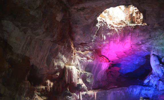 Inside view of Borra Caves formed by solidified stalactites and stalagmites in the karstic limestones formation located in the Araku Valley of the Ananthagiri hill range of the Visakhapatnam district in Andhra Pradesh india captured in dark condition.