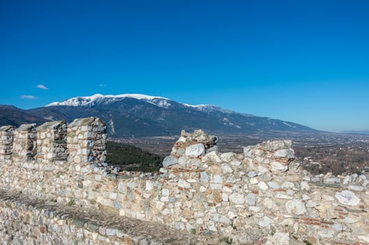 Wall of medieval castle of Platamonas with Olympus mountain at background. Pieria,  Greece