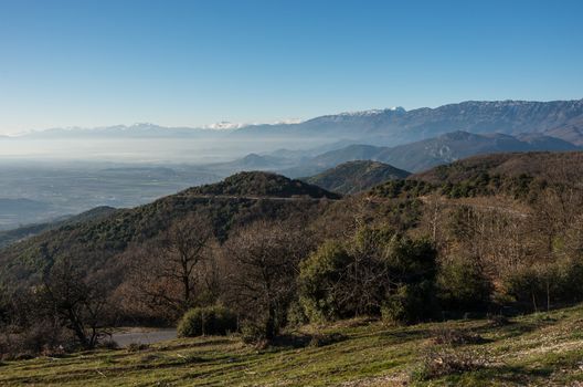 Landscape near Kalambaka town with Pindus mountains at background. Area near with monasteries and rock formations in Meteora, Greece.