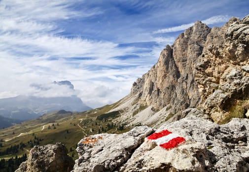 Trail mark on a stone in Dolomites, Italy