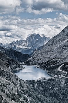 Fedaia lake in Dolomites with view of Marmolada mountain