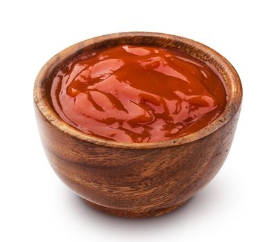 Ketchup in wooden bowl isolated on white background with clipping path