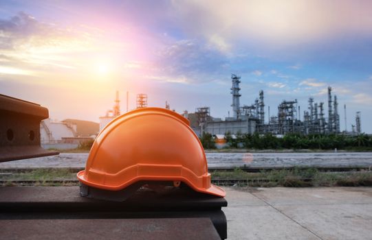 Helmet construction on the metal bar with industrial background.