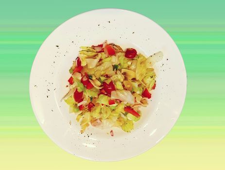 Mixed salad on a white dish in front of gradient background