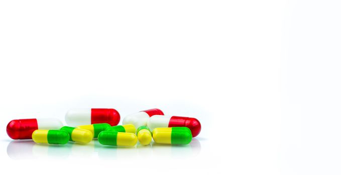 Colorful of capsule pills on white background with copy space for text. Pharmacology and drug interactions concept. Pharmaceutical industry. Pharmacy background. Global healthcare concept.