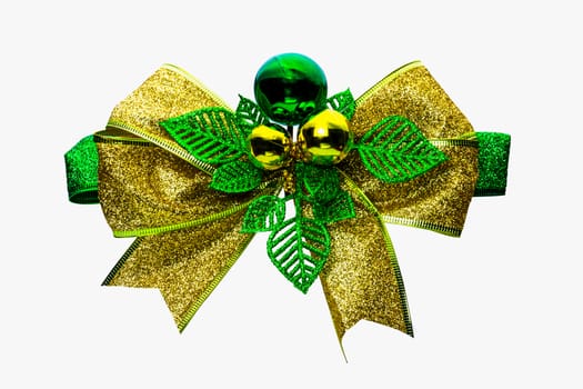 Shiny green and gold Christmas bow and ball isolated on white background with copy space. Ribbon for gift or present concept. Christmas decorative ribbon and Christmas ornament concept.