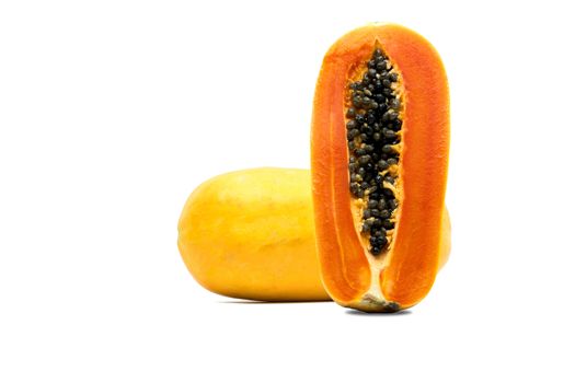 Whole and half of ripe papaya fruit with seeds isolated on white background with copy space. Natural source of vitamin C, folate and minerals. Healthy food for pregnant and breast feeding woman