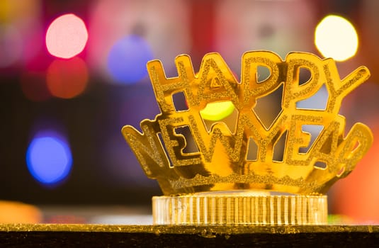 Golden Happy New Year headband on colorful bokeh background