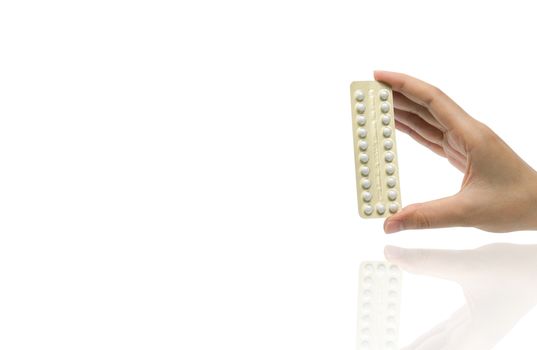 Asian adult woman hand holding pack of contraceptive pills isolated on white background with clipping path. Choosing family planning with birth control pills concept