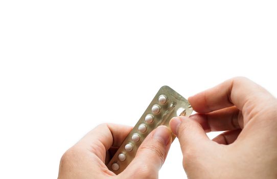Woman hand taking birth control pills. Asian adult woman holding pack of contraceptive pills isolated on white background with clipping path. Choosing family planning with birth control pill concept