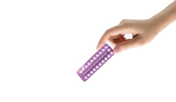 Woman hand taking birth control pills. Asian adult woman holding pack of contraceptive pills isolated on white background with clipping path. Choosing family planning with birth control pills concept