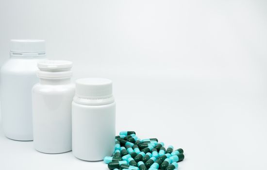 Antibiotic capsules pills and plastic bottle with blank label isolated on white background with copy space. Drug resistance concept. Antibiotics drug use with reasonable and global healthcare concept. Pharmaceutical industry. Pharmacy background. Health budgets and policy concept.