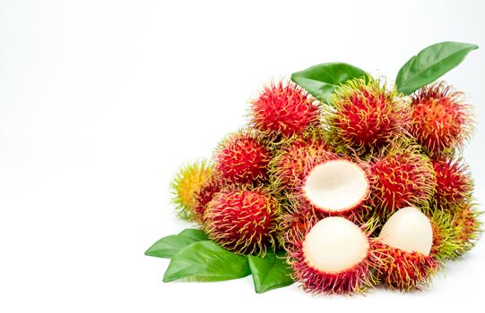 Closeup of fresh red ripe rambutan (Nephelium lappaceum) with leaves isolated on white background. Thai dessert sweet fruits. Tropical fruit.