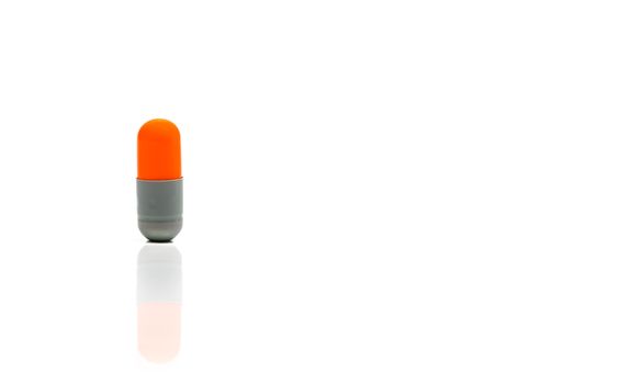 Orange, gray antibiotics capsule pill isolated on white background with copy space. Drug resistance concept. Antibiotics drug use with reasonable and global healthcare concept.
