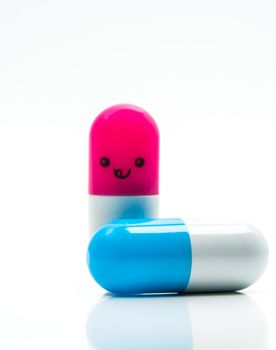 Cute blue and pink couple capsule pills isolated on white background with copy space for text. Global healthcare concept. Taking care of couple life. Pharmaceutical industry. Pharmacy sign and symbol. Pharmacy background. Health budgets and policy.
