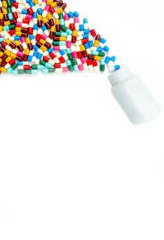 Antibiotic capsules spilling out of pill bottle on white background with copy space, just add your own text. Drug resistance concept. Antibiotics drug use with reasonable and global healthcare concept. Pharmaceutical industry. Pharmacy background.