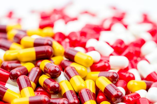 Selective focus of antibiotic capsules pills on blur capsule background. Drug resistance concept. Antibiotics drug use with reasonable and global healthcare concept. Pharmaceutical industry.