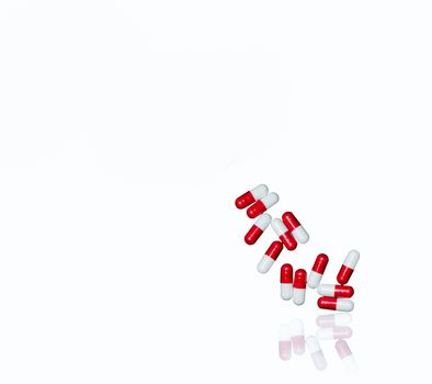 Red, white antibiotic capsules pills isolated on white background with copy space and clipping path. Antimicrobial drug resistance, antibiotic drug use with reasonable concept. Pharmacy background.