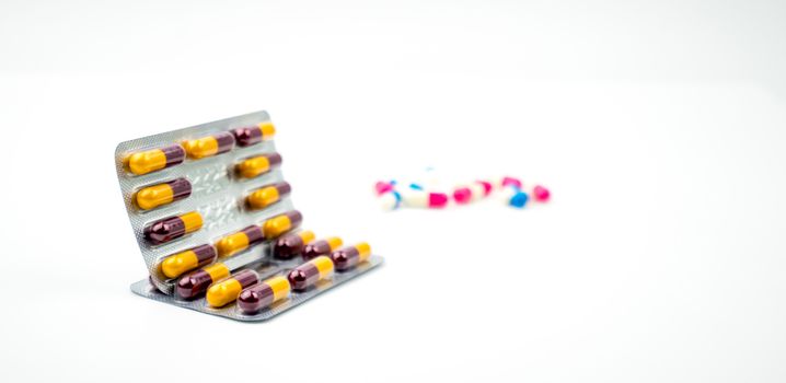 Colorful of antibiotic capsules pills on blurred background with copy space. Drug resistance, antibiotic drug use with reasonable, health policy and health insurance concept. Pharmaceutical industry. Pharmacy background.