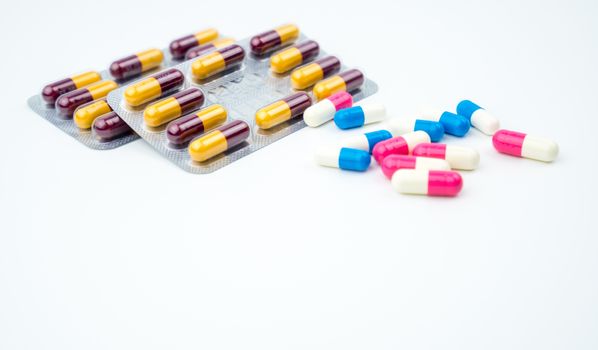 Colorful of antibiotic capsules pills on white background with copy space. Drug resistance, antibiotic drug use with reasonable, health policy and health insurance concept. Pharmaceutical industry. Pharmacy background.