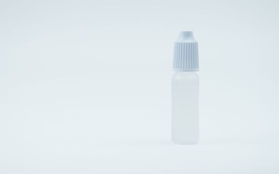 Eye drops bottle with white cap on white background with blank label and copy space, just add your own text. Dry eye disease from smartphone use, digital screen. digital eye strain.