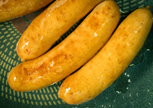 Fried pork sausage in a pan. Unhealthy food. Food can cause rectal and colon cancer.