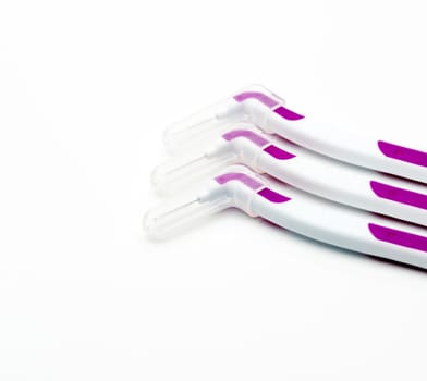 Three interdental brush with cover isolated on white background with copy space.