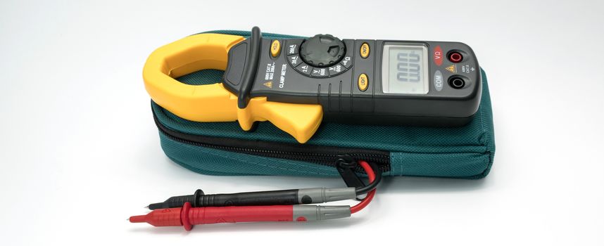 Digital clamp meter with probes on white background