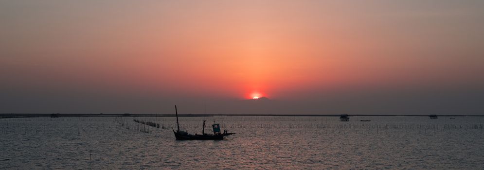 Beautiful sunset above the sea with ship