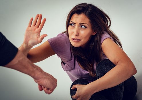 Aggressive husband is physically abusing his wife. 