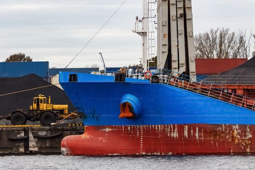 Blue cargo ship loading in the port of Riga, Europe