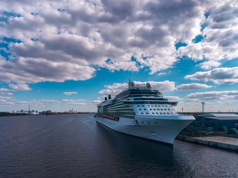Big white passenger ship moored at the cargo port
