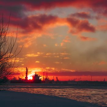 Colorful winter sunrise against the cargo port