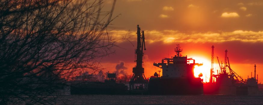 Colorful winter sunrise against the cargo port