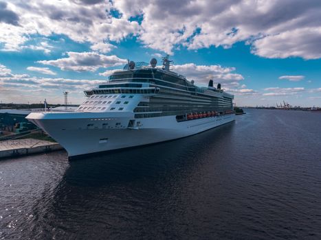 Big white passenger ship moored at the cargo port