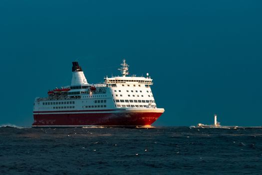 Red cruise liner. Passenger ship sailing from the sea in the morning