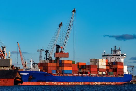 Blue container ship loading in cargo port of Europe