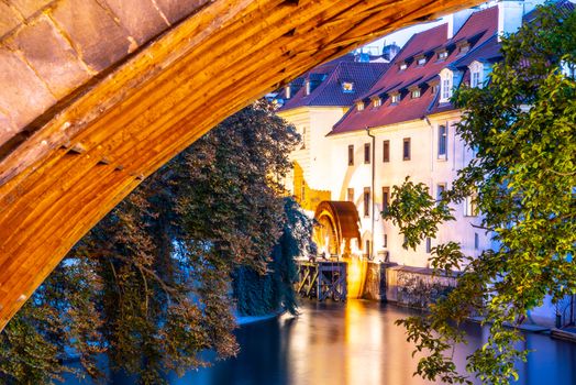 Certovka River and old Water mill under Charles Bridge, Lesser Town of Prague, Czech Republic.