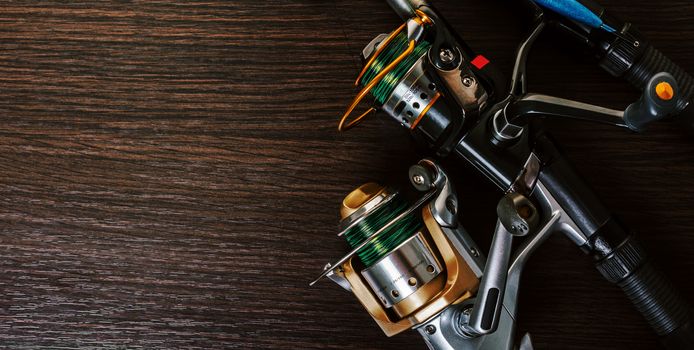 fishing rod with a coil on wooden background