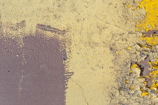 fragment of an iron surface is covered with brown and beige color paint, which has long been under the influence of different climatic conditions