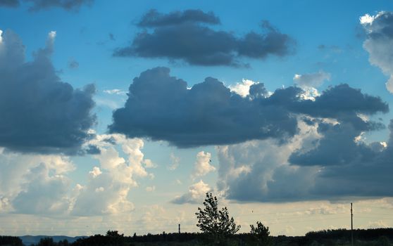 White and dark blue clouds on sky during sunset