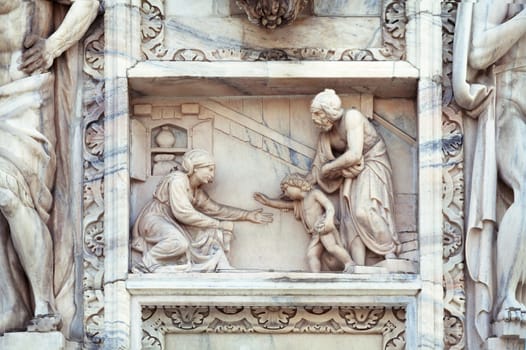 Statue on the wall of cathedral in Milan, Italy