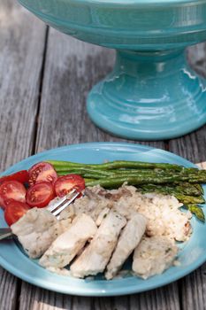 Sauteed pork and asparagus with mushroom risotto meal on a rustic dinner plate