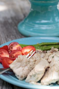 Sauteed pork and asparagus with mushroom risotto meal on a rustic dinner plate