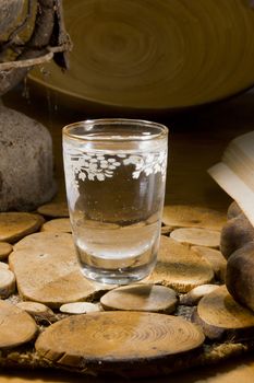 Glass of vodka on an old wooden table